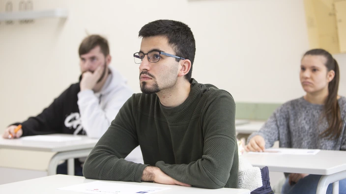 Drei Schüler sitzen im Unterricht