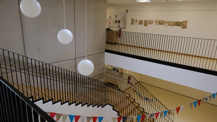 Treppenaufgang mit Wimpelkette und Bildern an der Wand